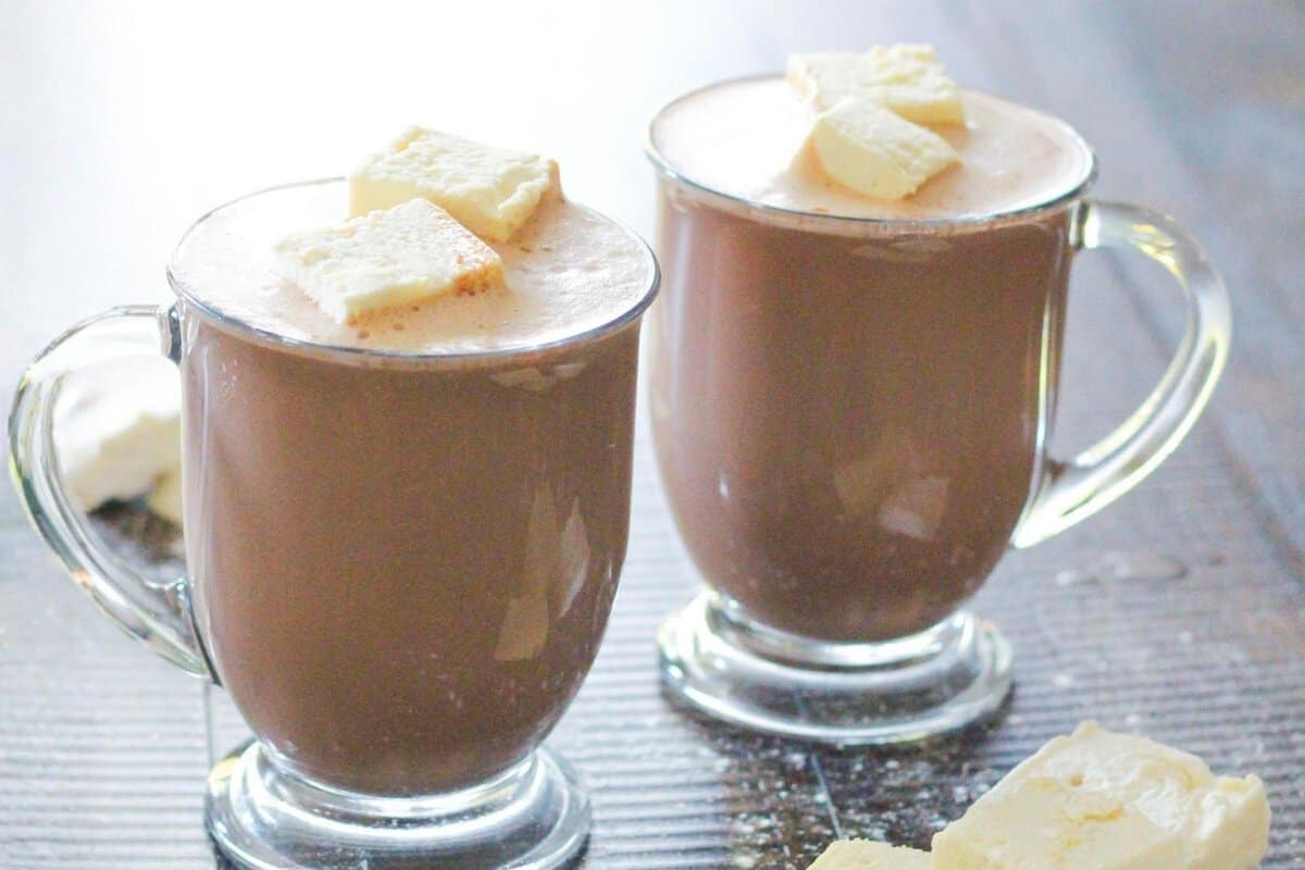 two mugs of protein powder hot chocolate topped with marshmallows