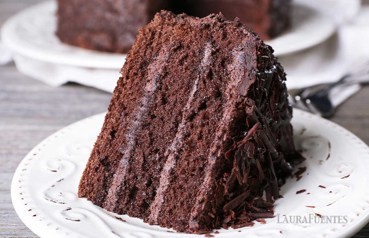 a slice of chocolate cake on a white plate.
