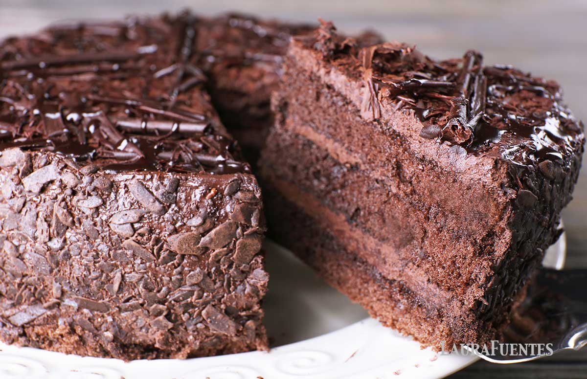 a chocolate cake on a plate from which a slice is taken