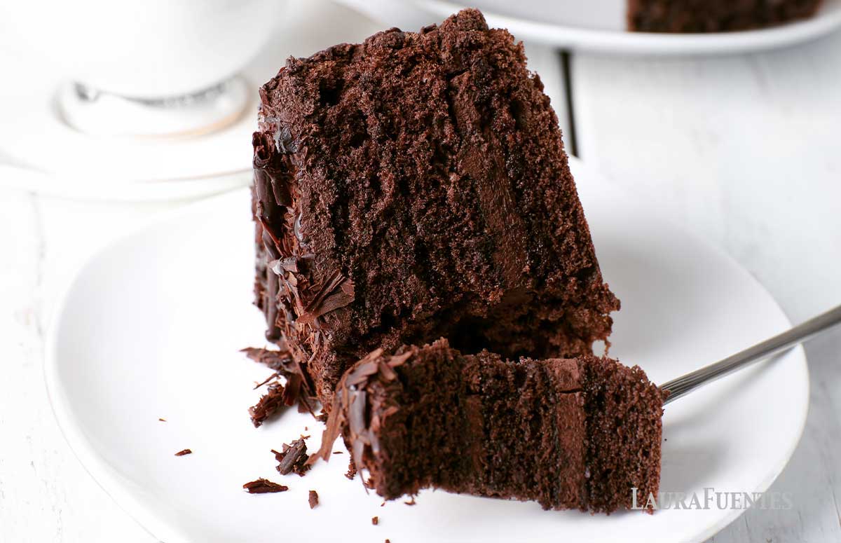 a slice of chocolate cake on a white plate.
