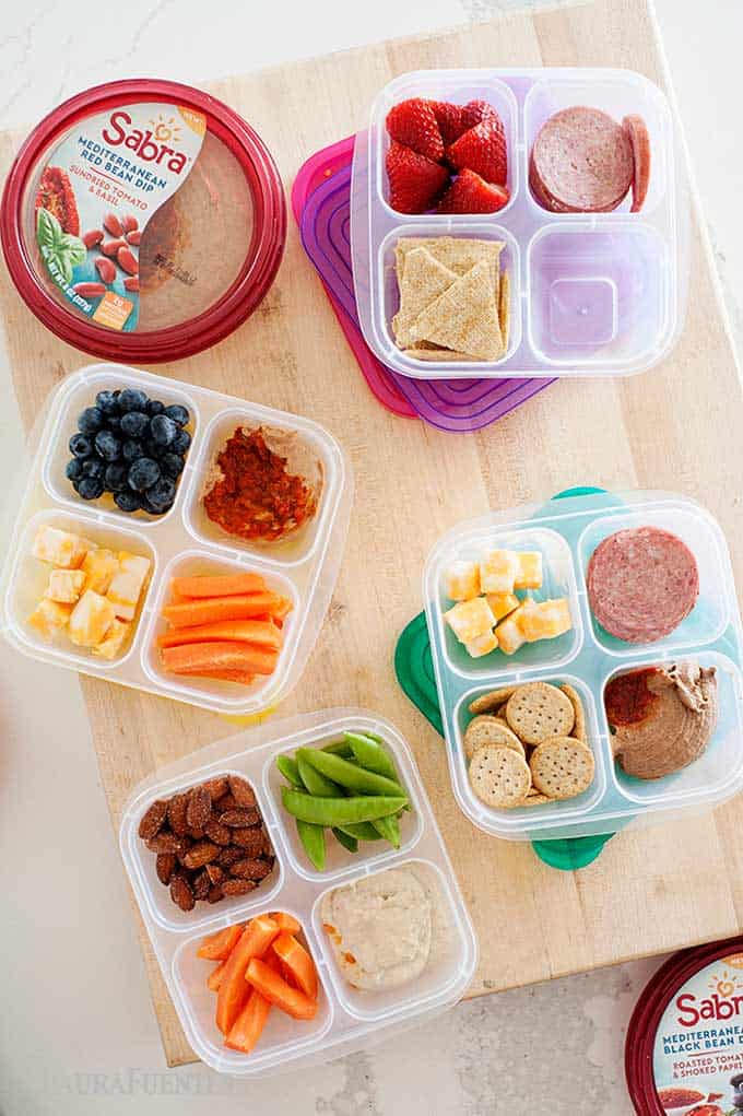antipasto snack boxes with fruits, veggies, and hummus
