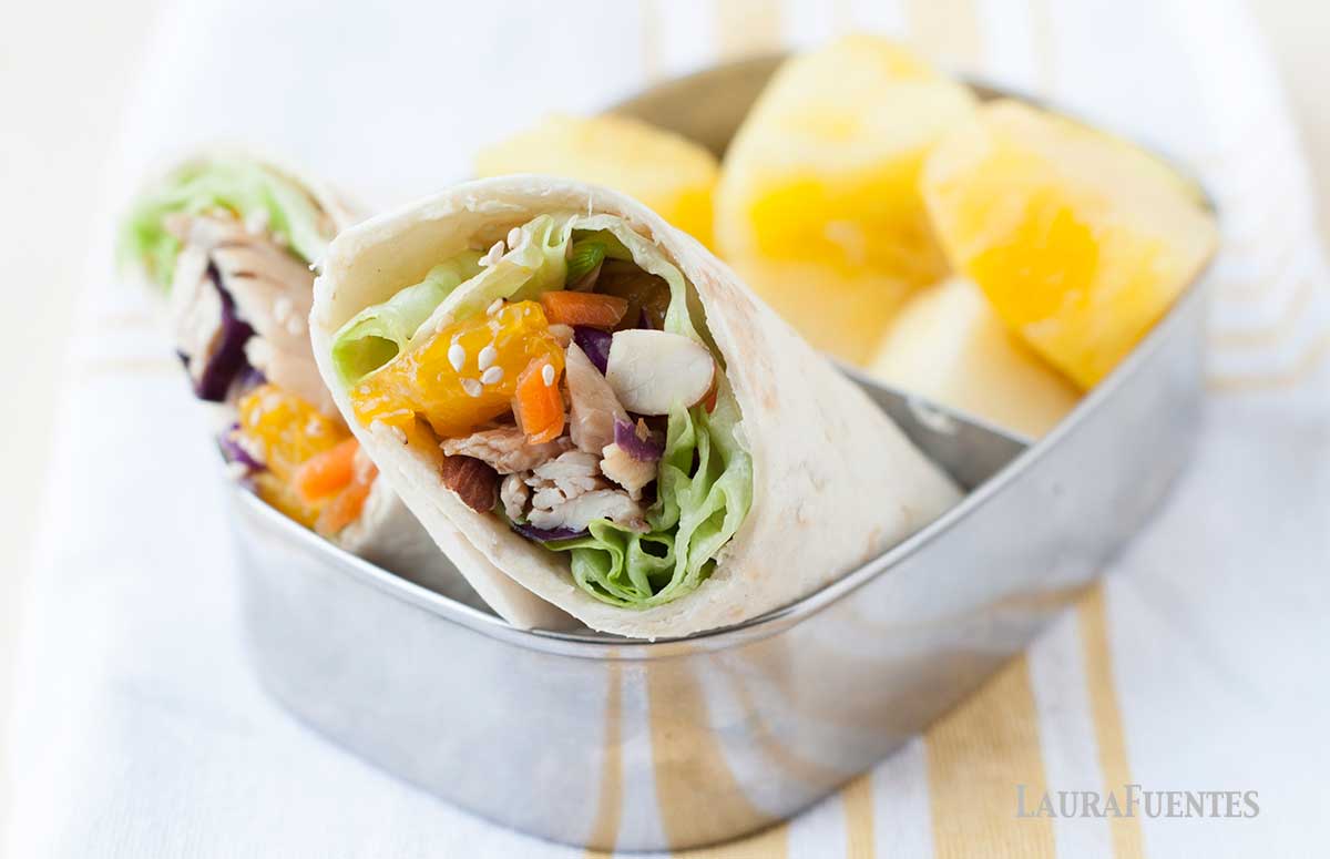 asian chicken wrap with fresh pineapple in a lunchbox