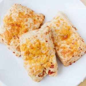 overhead view of pepperoni and cheese pizza stuffed biscuits on a white plate