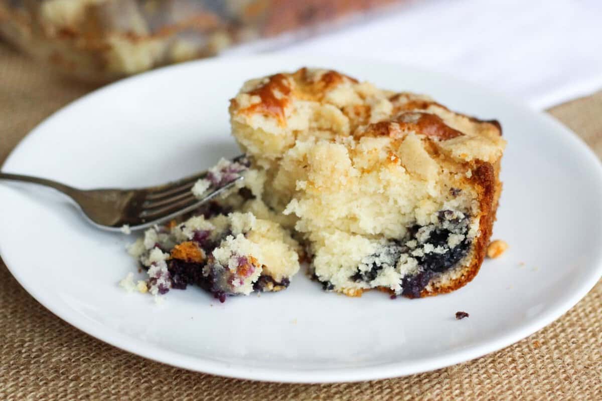 a slice of blueberry coffee cake on a plate
