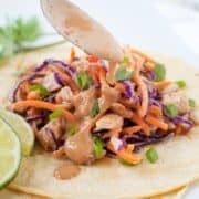thai chicken taco with being drizzled with peanut sauce
