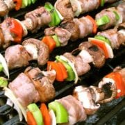 steak, peppers, mushroom, and onion kabobs on a grill