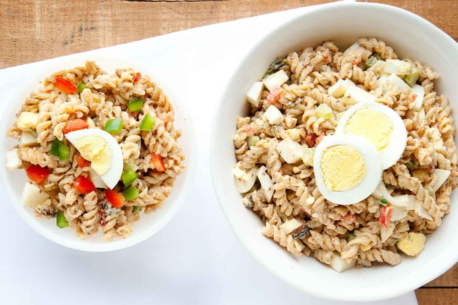 one large bowl and one small bowl of Cajun Jambalaya pasta with hard boiled egg slices on top