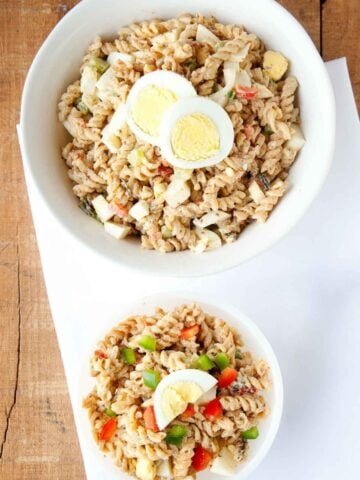 one large bowl and one small bowl of Cajun Jambalaya pasta with hard boiled egg slices on top