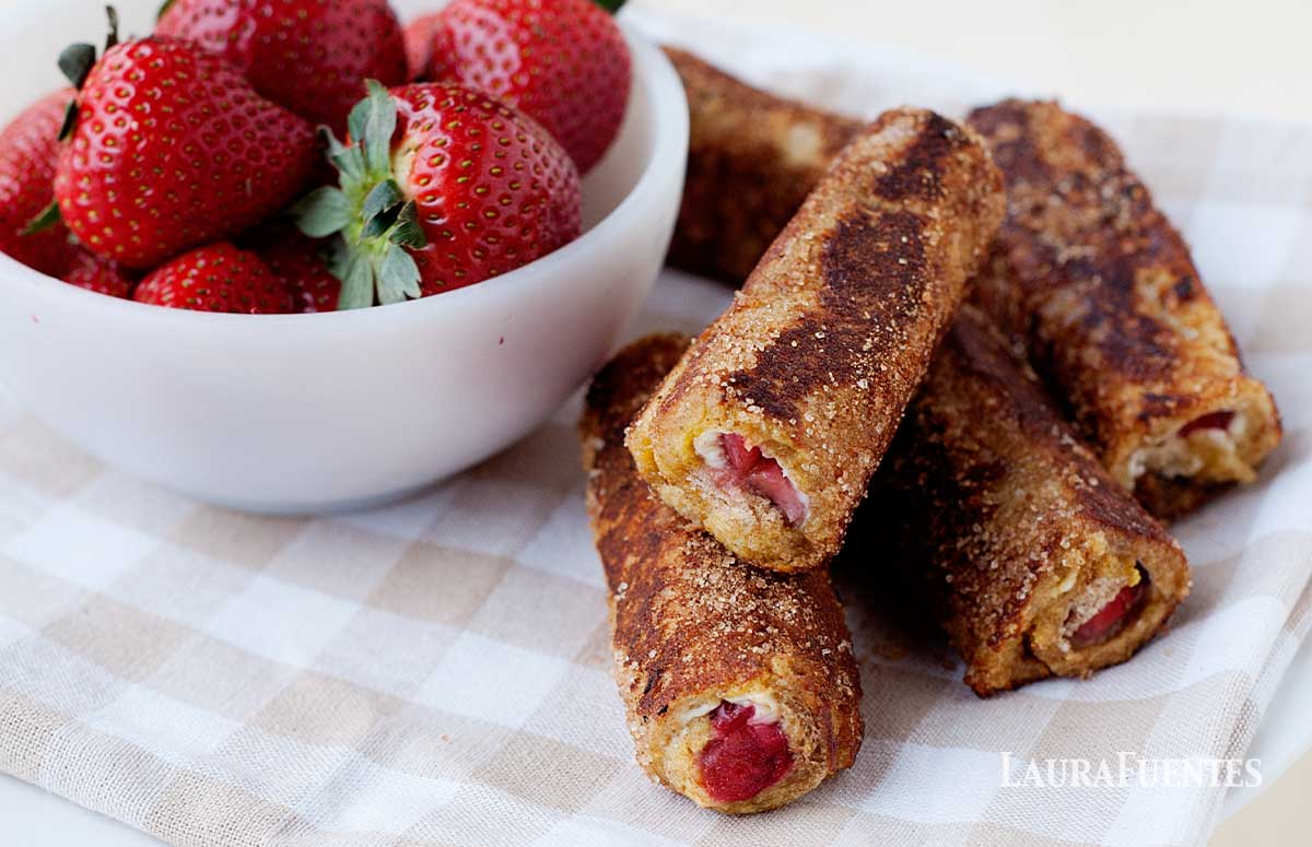Strawberry and Cream Stuffed French Toast on a napkin with strawberries on the side