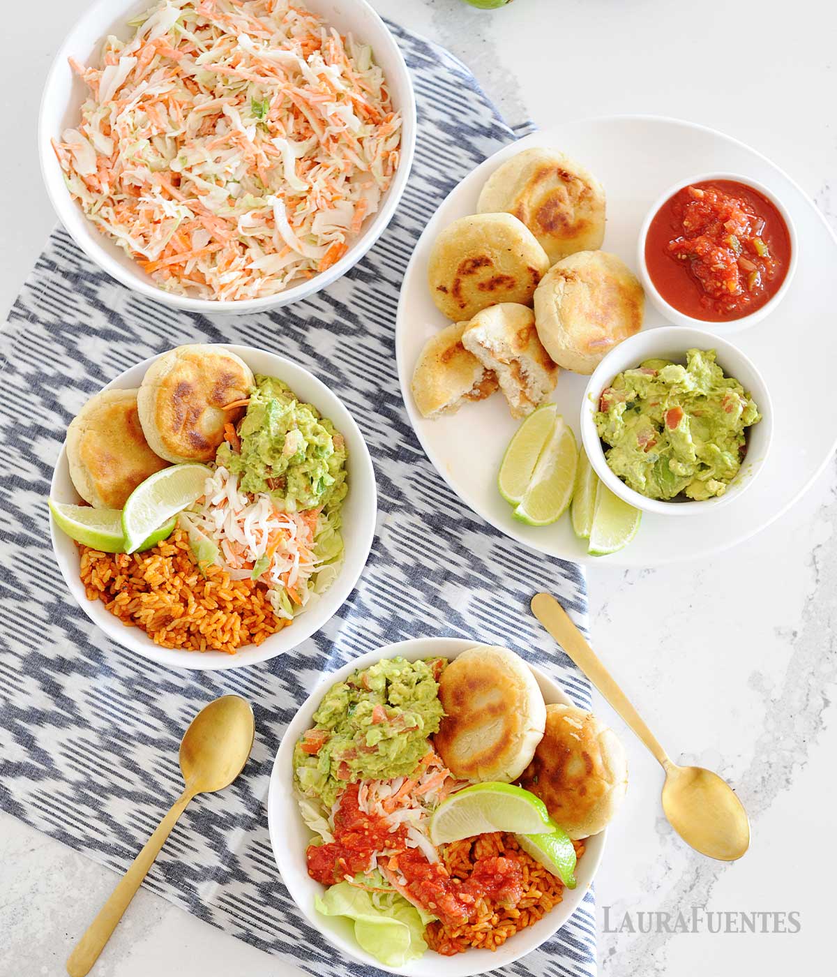 overhead view of healthy pupusas and curtido bowls with guacamole, coleslaw and salsa in white bowls