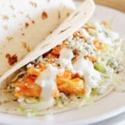 slow cooker buffalo chicken tacos on a plate