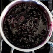 blueberry syrup cooking in a pan on the stove