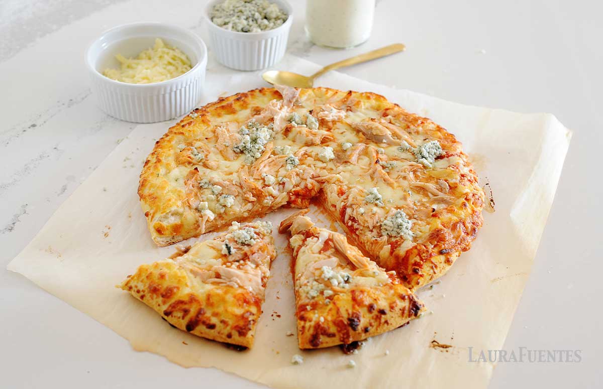 loaded buffalo chicken pizza slices on a baking paper