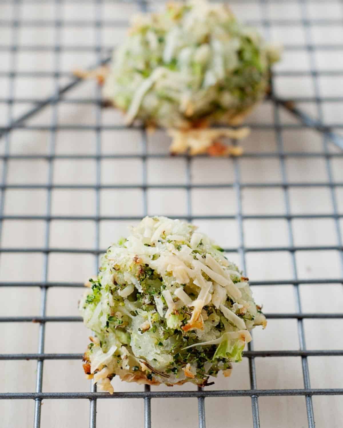 closeup of cheesy broccoli tots on a cooling rack