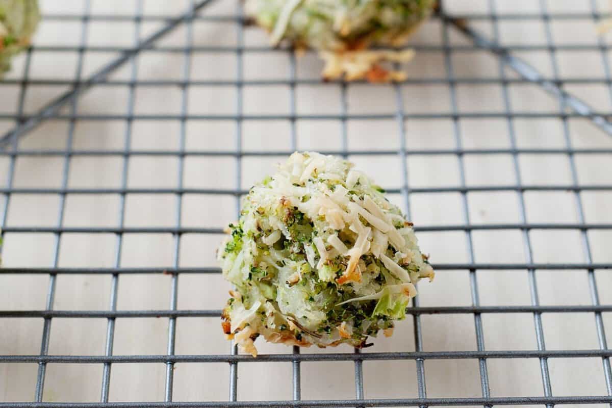 closeup of cheesy broccoli tots on a cooling rack