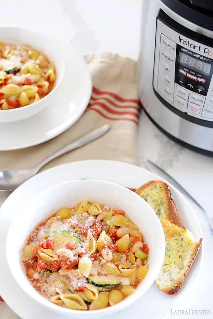 minestrone soup in a bowl in front of Instant Pot