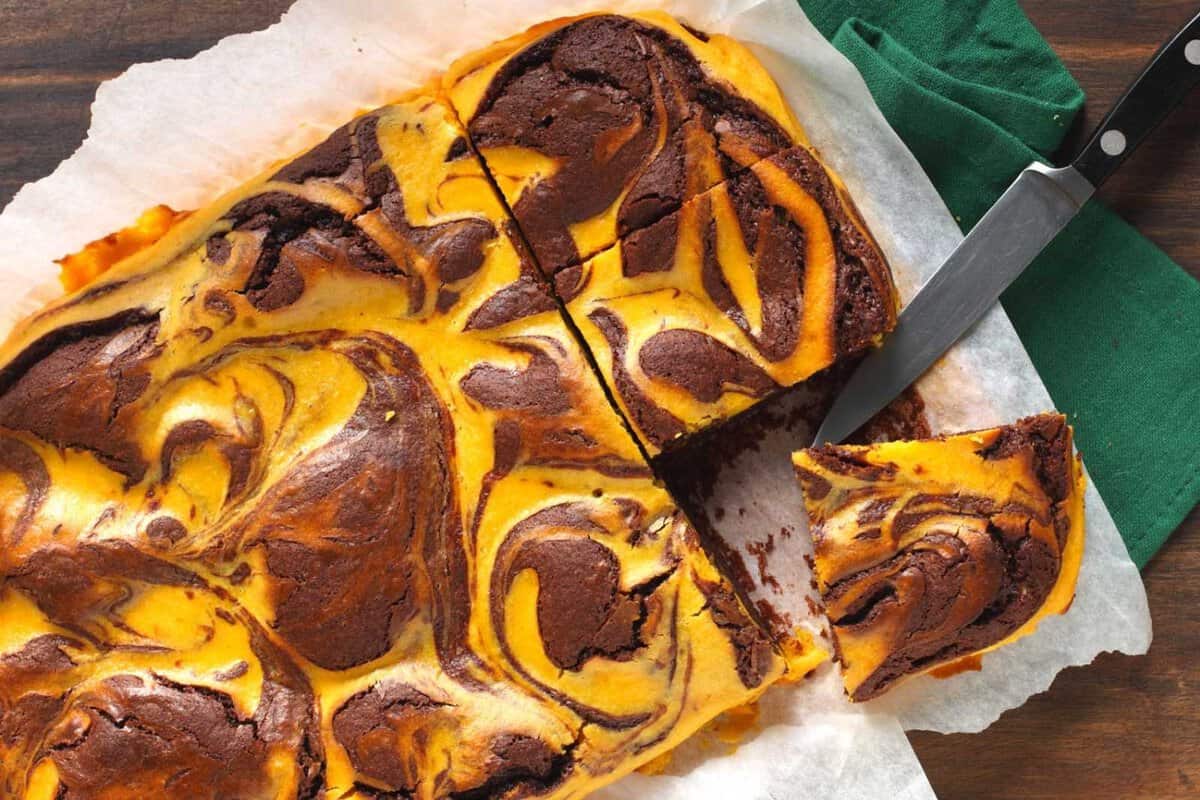 overhead view of a piece of pumpkin brownie being sliced