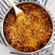 skillet of homemade goulash topped with cheese