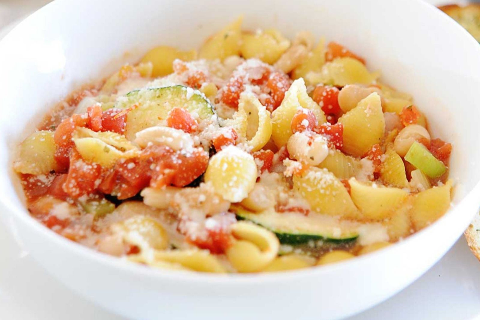 a white bowl with minestrone soup