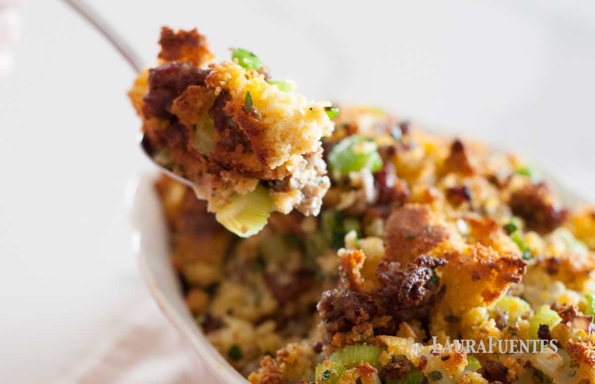 dish of cornbread stuffing with spoon pulling out of it
