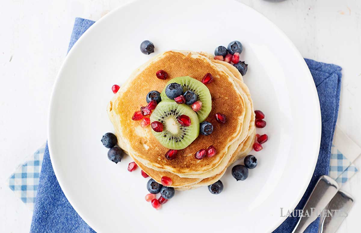 overhead view of pancake stack topped with fruit