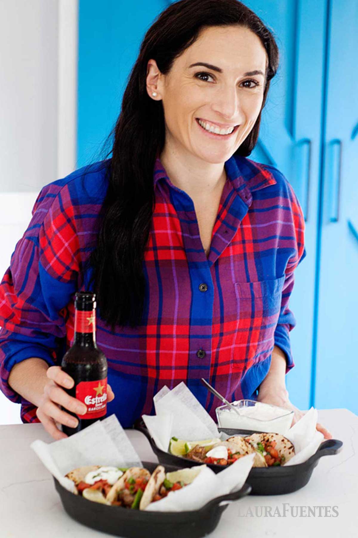 a woman in front of two plates of slow cooker chicken