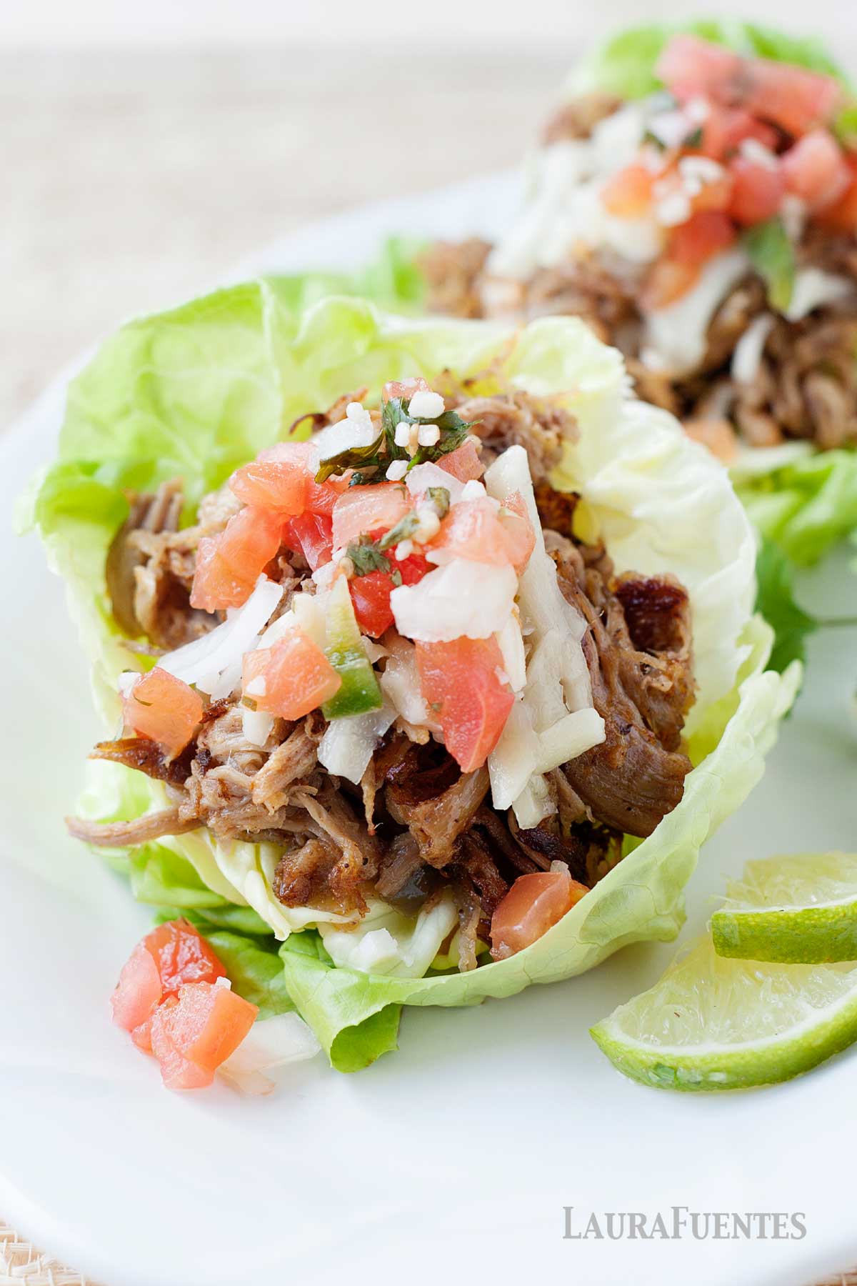 pork carnitas lettuce wraps on a white plate