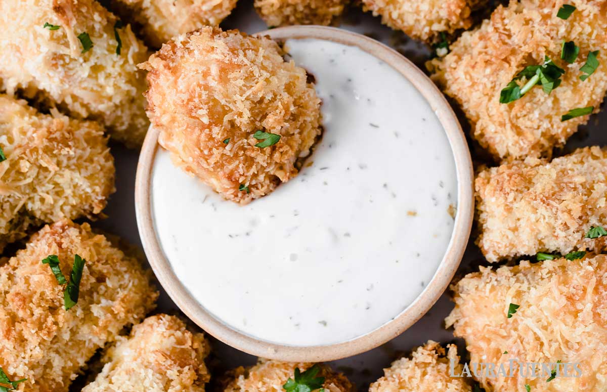 Homemade salmon nuggets in a bowl with dip in the middle