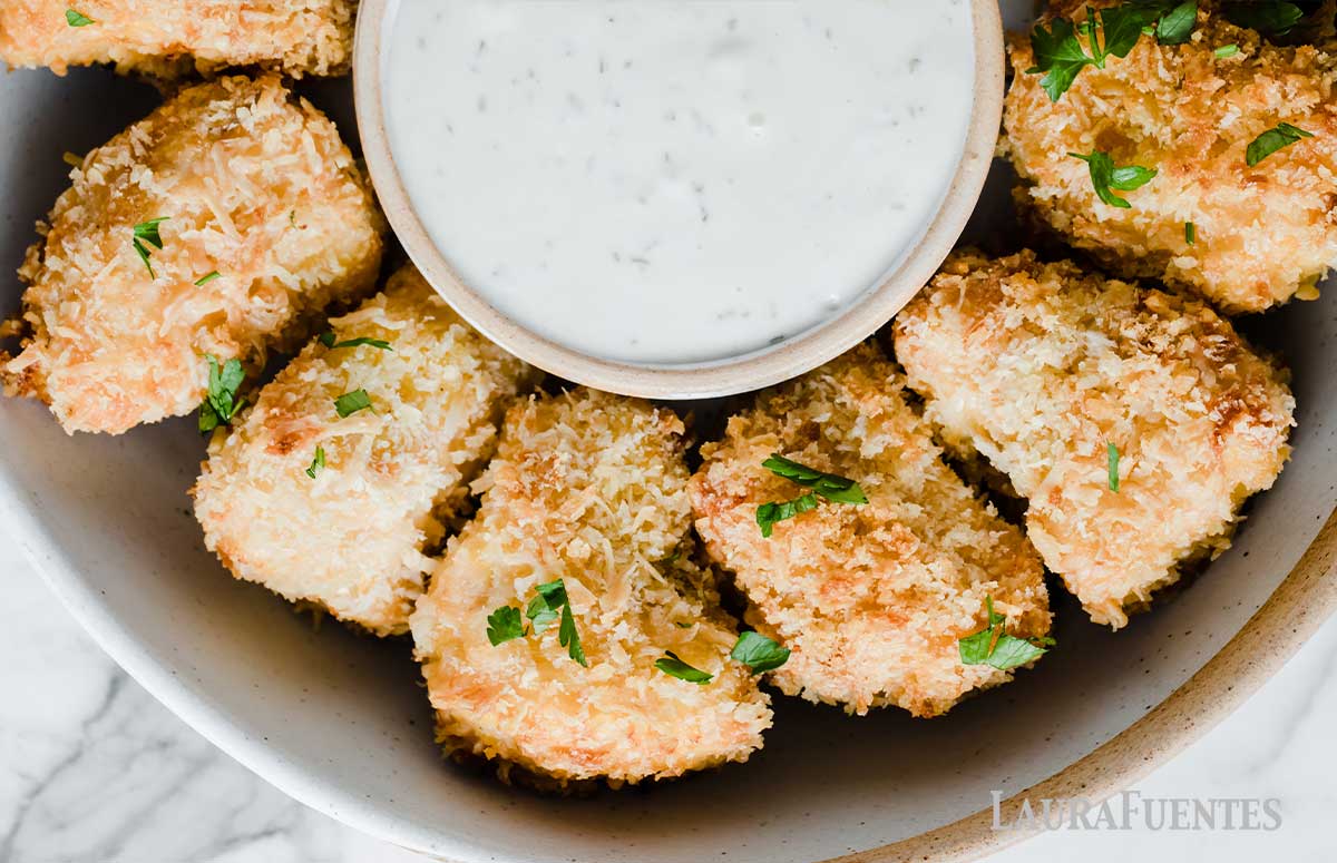 Homemade salmon nuggets in a bowl with dip in the middle