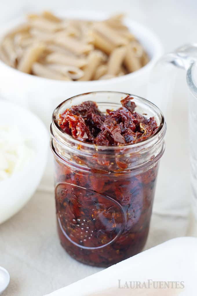 image: small glass jar filled with sun dried tomatoes.