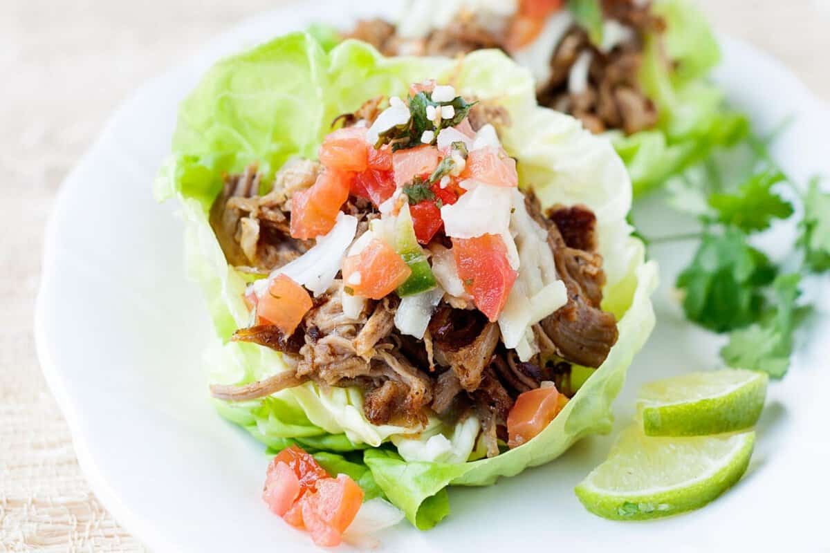 carnita lettuce cups on a white plate