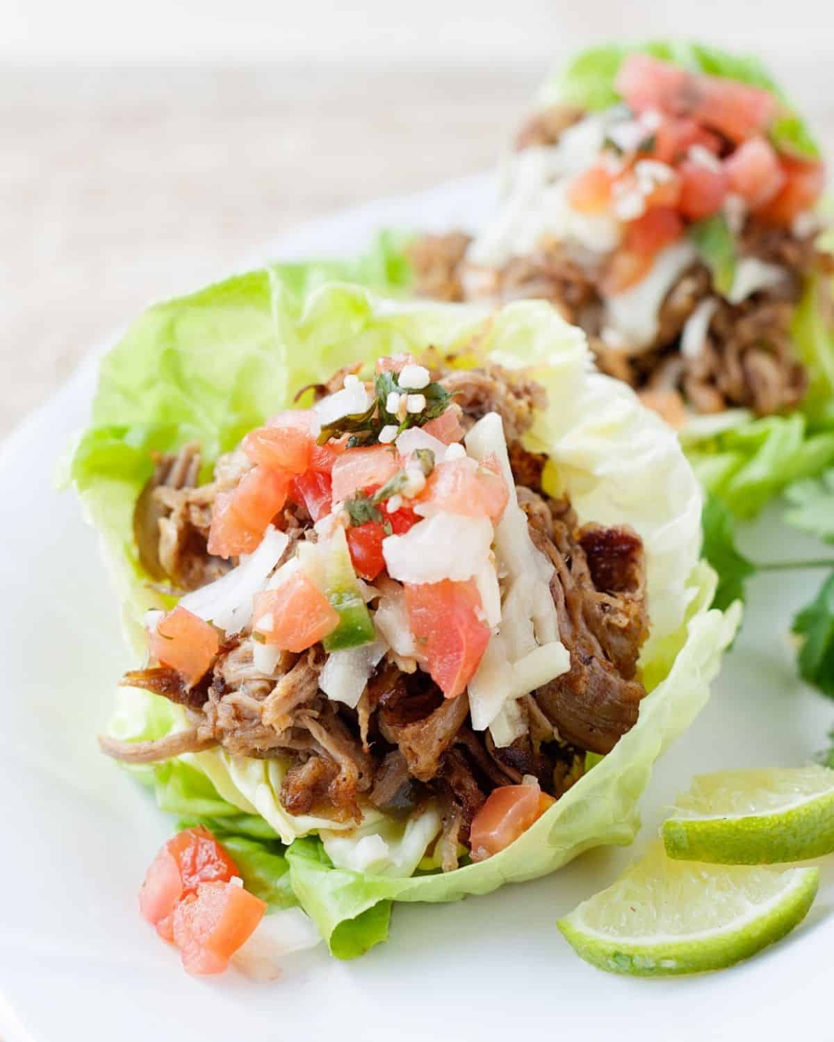 carnita lettuce cups on a white plate
