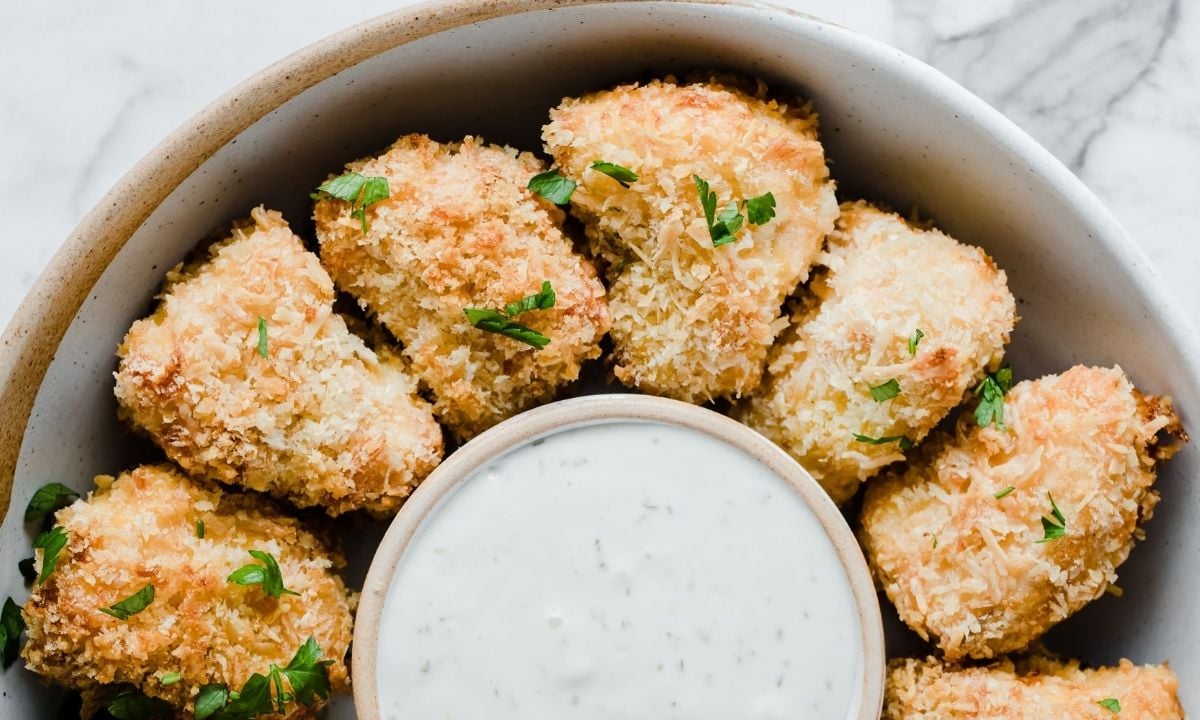 homemade salmon nuggets in a bowl with dip in the middle