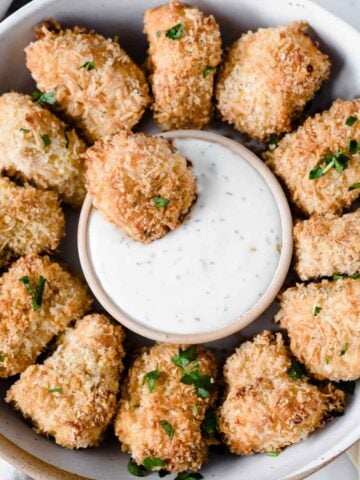 homemade salmon nuggets in a bowl with dip in the middle