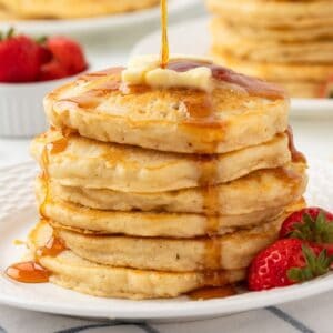 gluten-free pancakes stacked and topped with butter and syrup