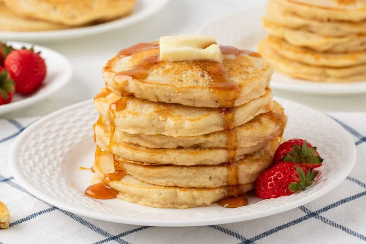 gluten-free pancakes stacked and topped with butter and syrup