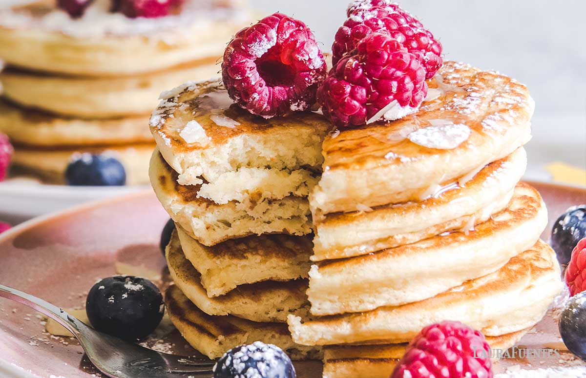 stack of gluten free pancakes topped with raspberries