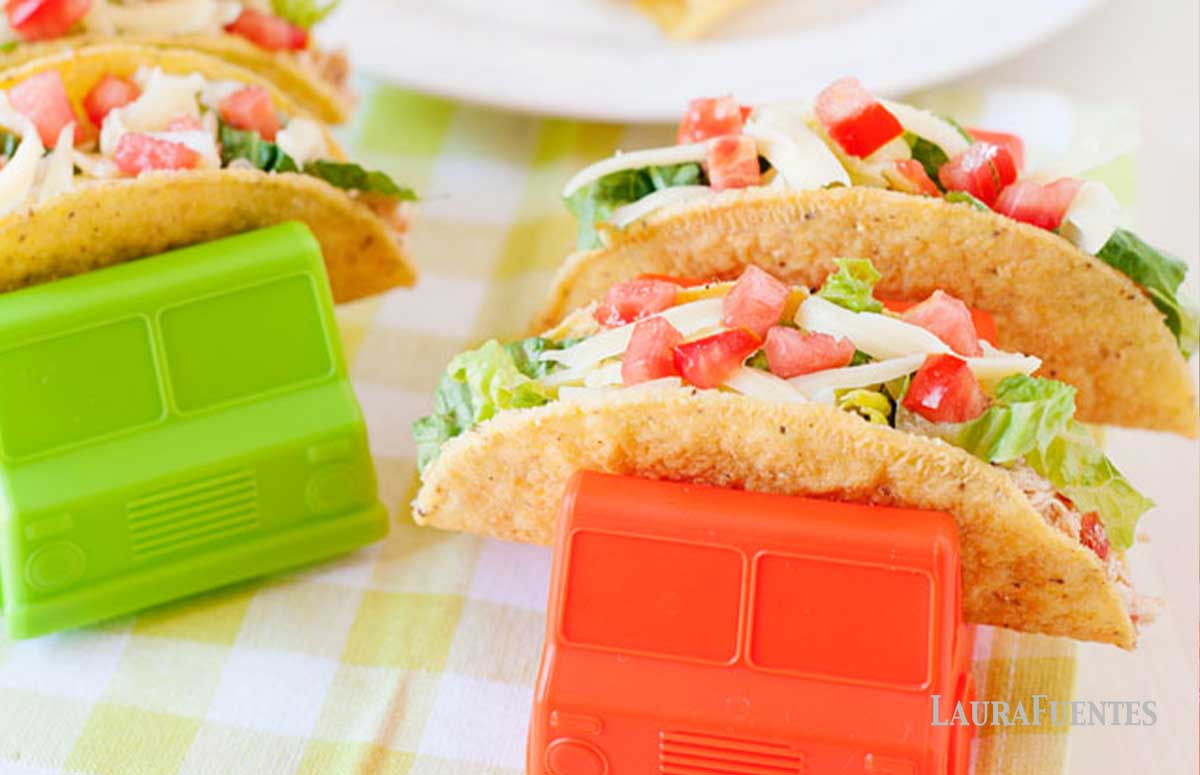 salsa chicken tacos in truck shaped taco holders and taco shells in the bachground