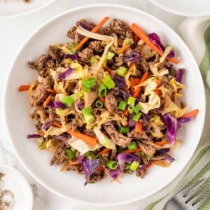 overhead view of a bowl with deconstructed eggroll containing cabbage, veggies, and meat.