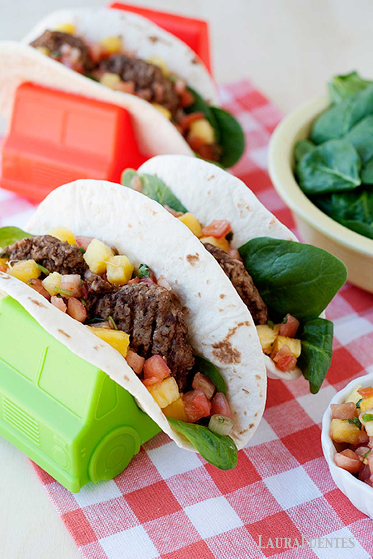 three breakfast sausage tacos in taco holders