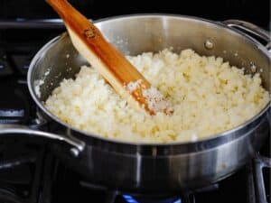 cauliflower rice in a skillet on the stove