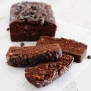 loaf of double chocolate banana bread with three slices cut out