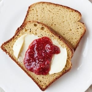 two slices of paleo bread with butter and strawberry jam in a plate
