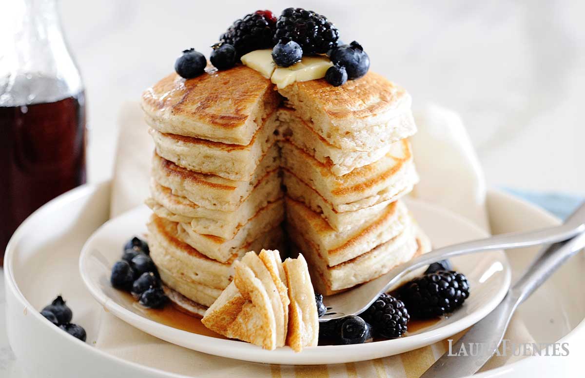 a stack of cassava flour pancakes on a white plate with blueberries on top