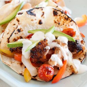 blackened salmon fajita tacos in a white dish