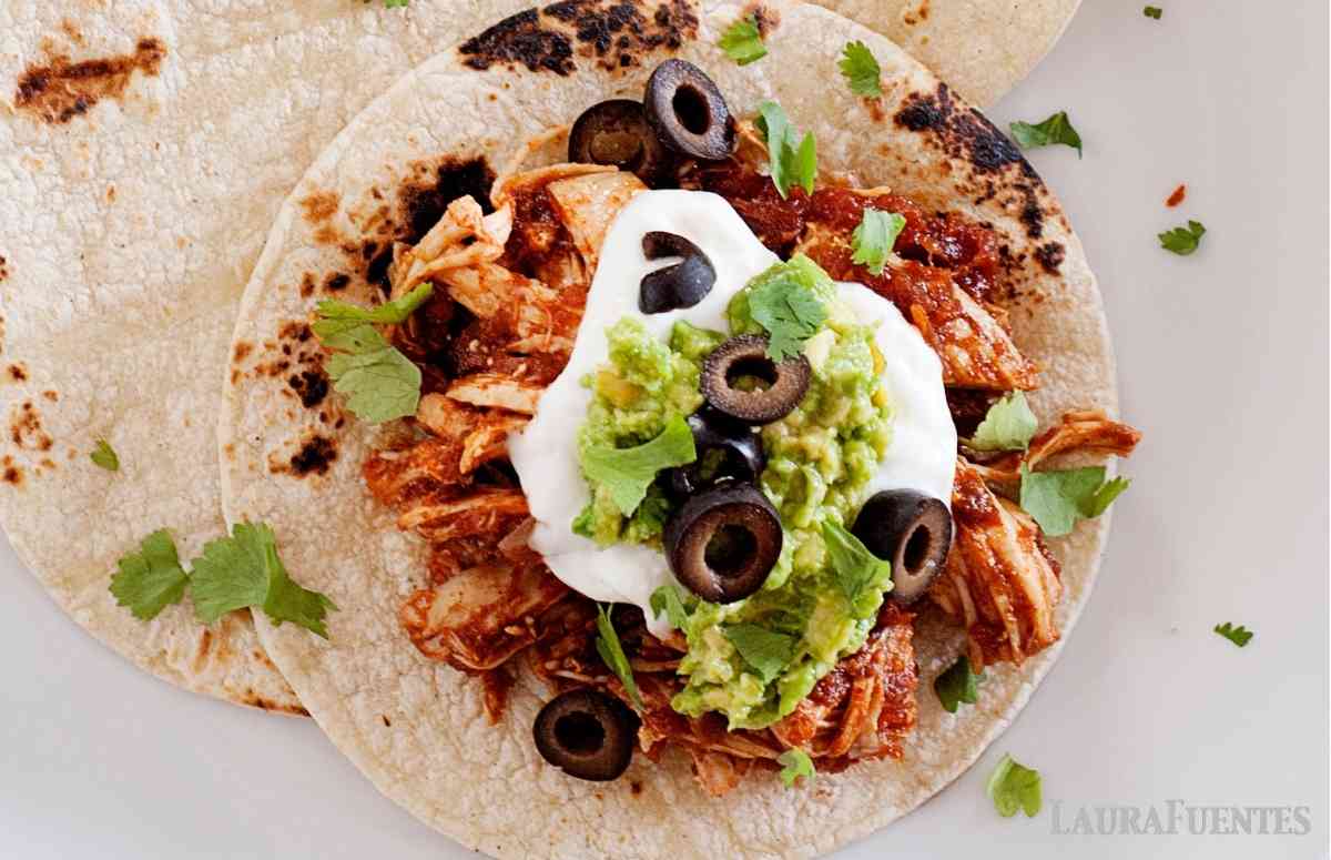 overhead look at shredded chicken enchilada tacos
