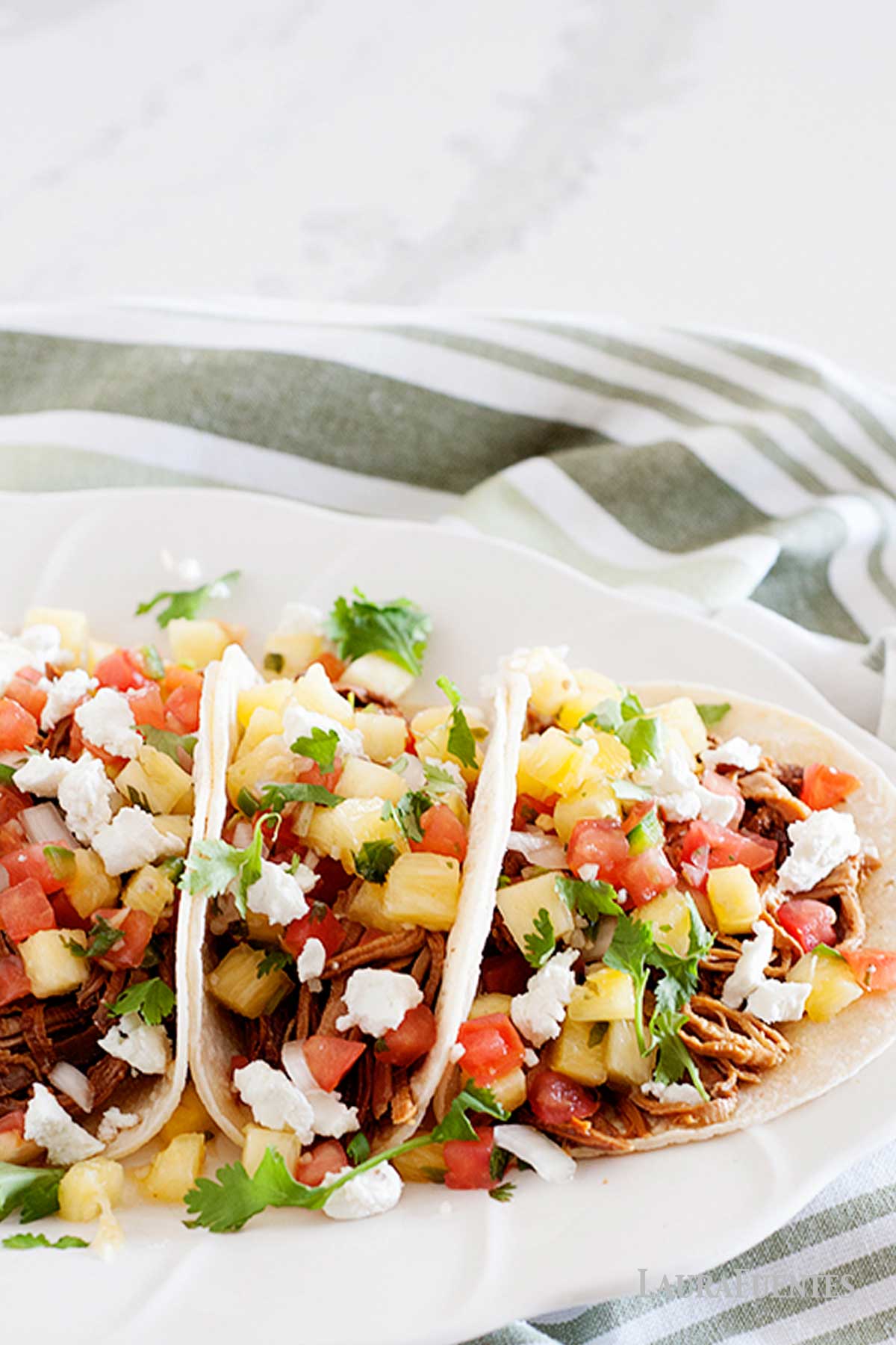 pineapple pork tacos on a plate