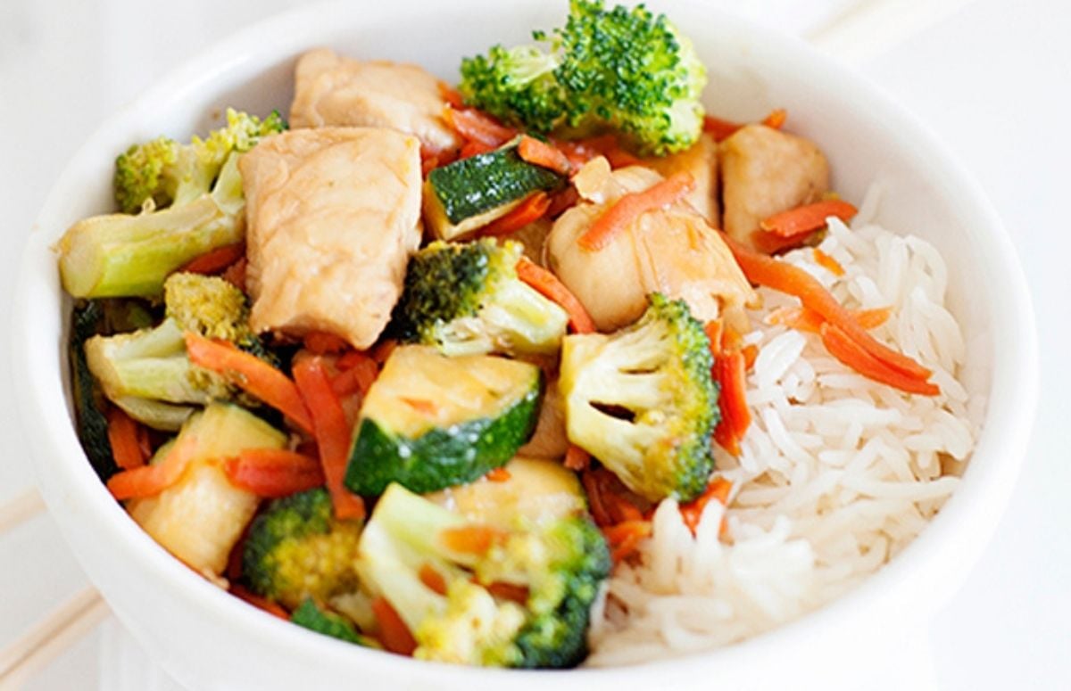 a bowl of chicken and zucchini stir fry