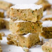 zucchini cake bars being sprinkled with sugar
