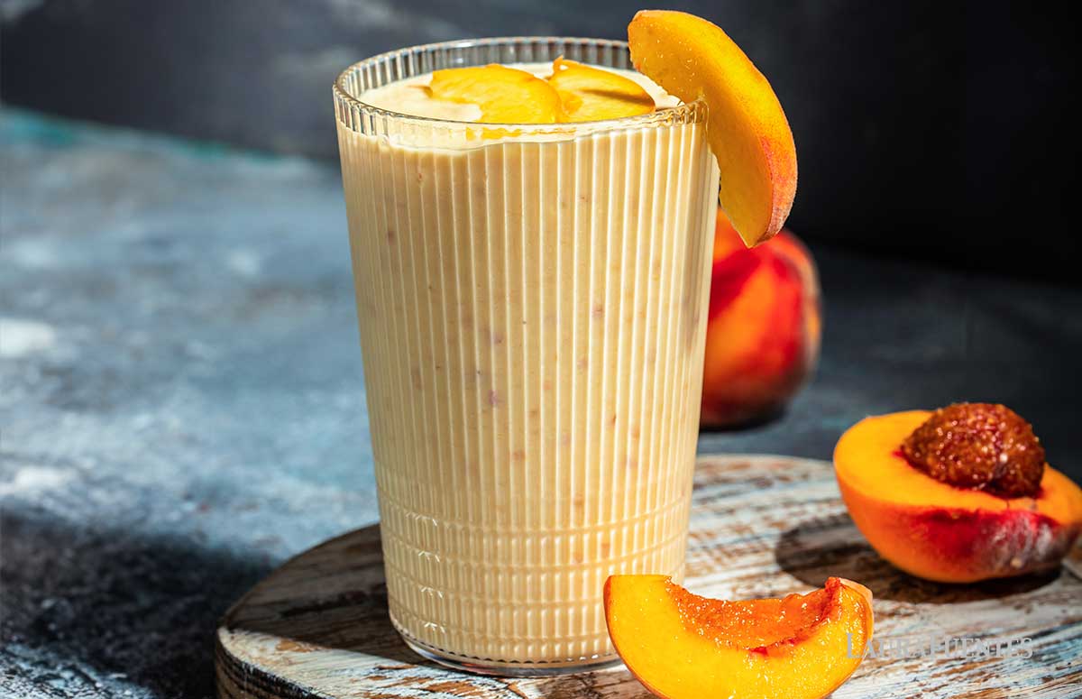 a glass of peach smoothie